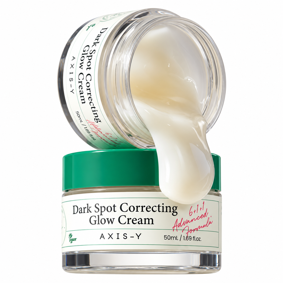 A jar of AXIS-Y Dark Spot Correcting Glow Cream with a green lid, shown with another jar tipped over pouring the cream onto the front jar. The cream is thick and off-white, and the background is solid white.