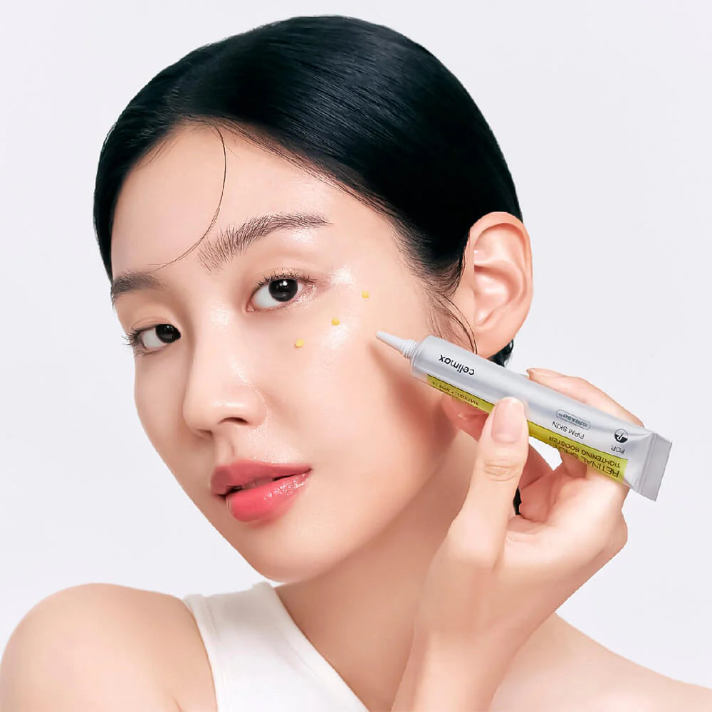 Woman applying skincare product to face with a white background