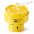 Goodal Green Tangerine Vita-C Eye Gel Patch in a bright yellow jar with a white spoon showing the translucent yellow gel patch inside, on a white background.