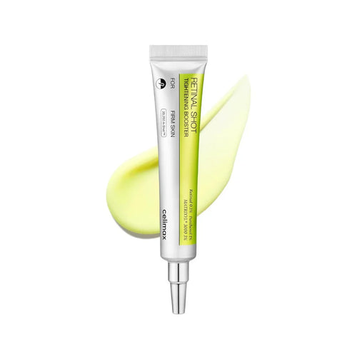 Skincare serum tube with a yellow smear on a white background