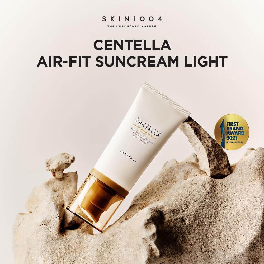 SKIN1004 Centella Air-Fit Suncream Light tube on a natural stone background with brand logo and award badge.