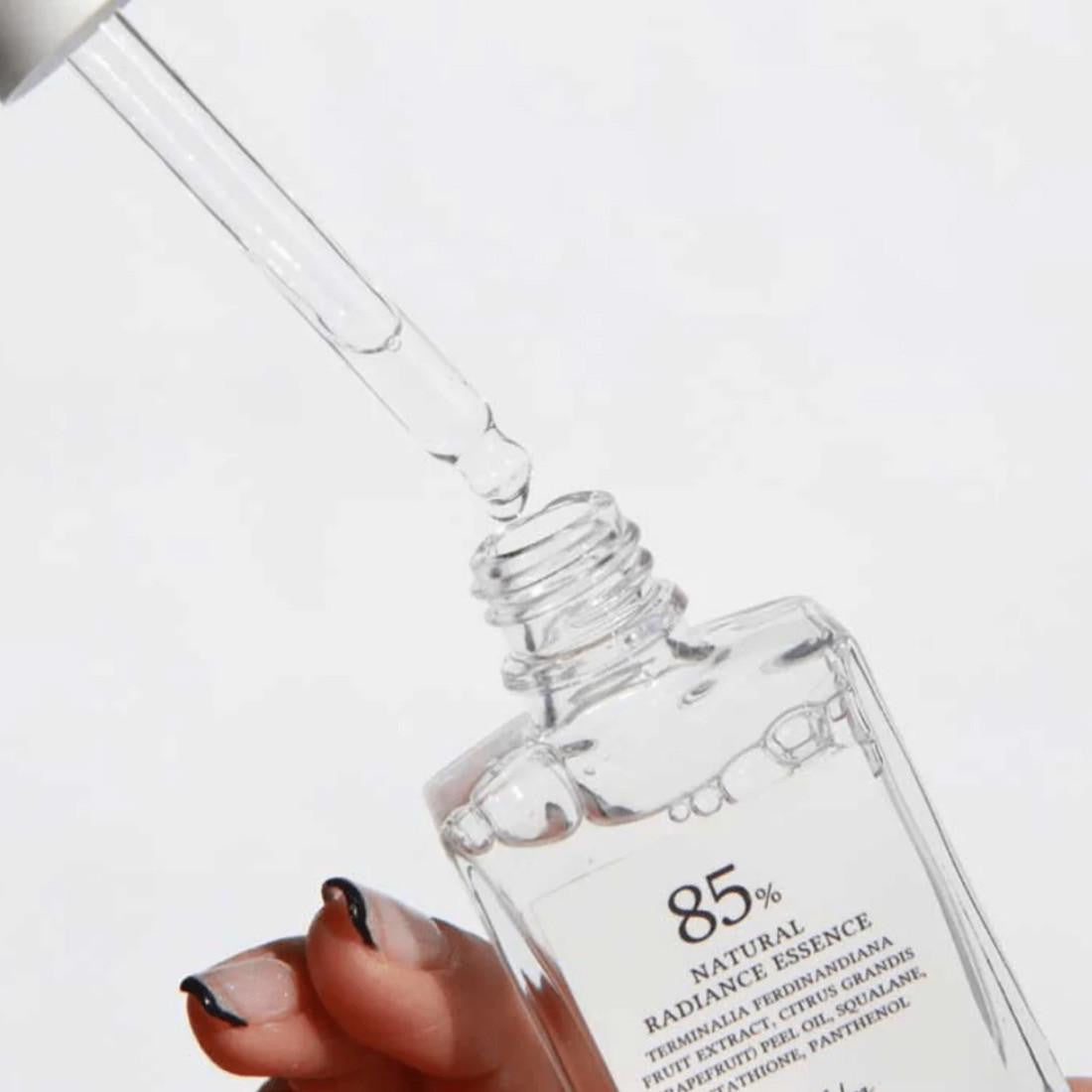Clear dropper bottle with text on a white background