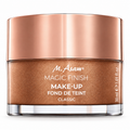 M. Asam Magic Finish Make-Up Classic bronze shimmer powder in a clear glass jar with a metallic rose gold lid, on a white background.