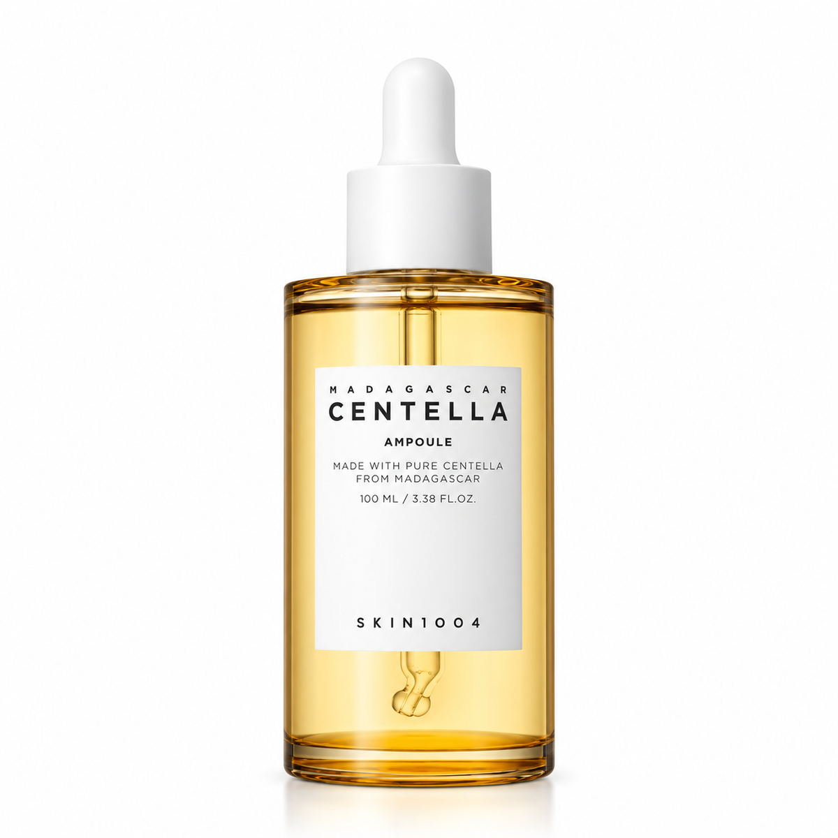 A 100ml glass ampoule of SKIN1004 Madagascar Centella Ampoule, featuring a golden-yellow liquid inside a clear bottle with a white dropper cap, set against a plain white background.