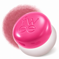 A bright pink and white spherical cosmetic container with the brand name 'fw ee' embossed on the lid, shown against a white background with a soft pink powder cloud behind it.