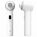 A white handheld beauty device shown from two angles on a plain white background: one front view with a circular treatment head, a small black display window, and a power button, and one side view showing the angled head and side button.
